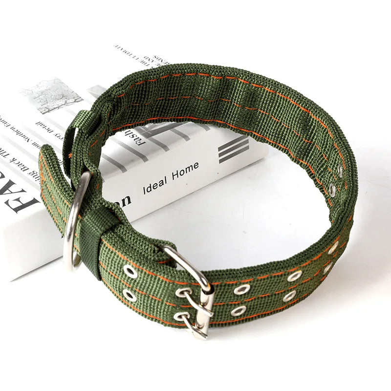 A dark olive green heavy duty tactical dog collar with an adjustable metal buckle lying on a book.