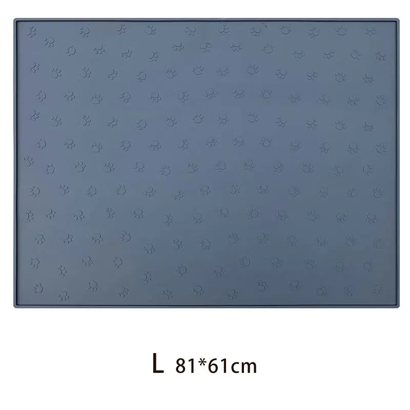 A rectangular gray silicone pet feeding mat with a non-slip surface featuring multiple small, embossed patterns.