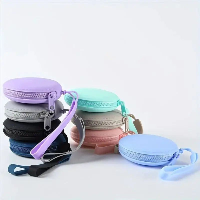 A collection of purple, mint green, and gray silicone pet treat pouches with attached straps.