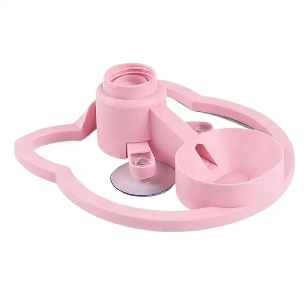 A pink gravity cat water dispenser with a bowl and a fitting for dispensing water.
