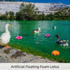 Set of 7 artificial floating foam lotus flowers with water lily pads in clear green water.