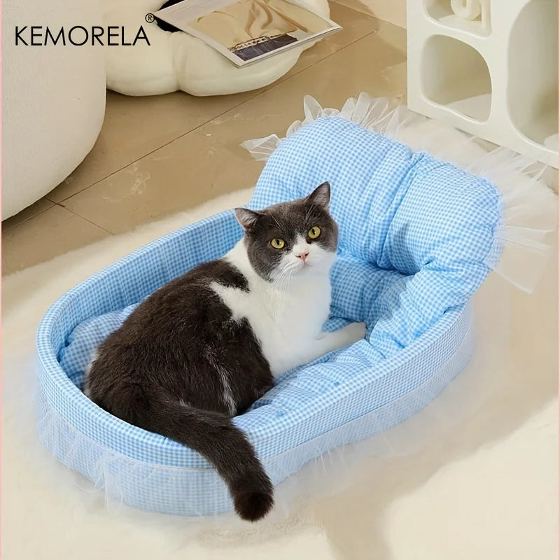 A gray and white cat is resting in a light blue checkered pet bed mat.