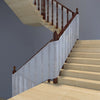 A wooden staircase with a safety mesh barrier installed along the railing.