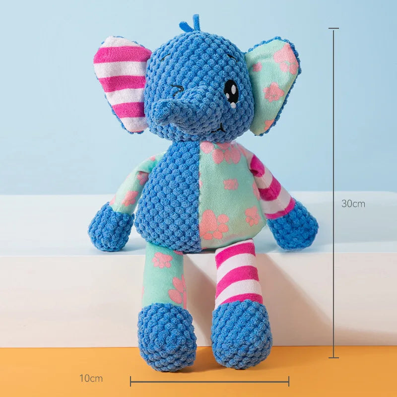 A blue elephant plush toy with pink and white striped ears and body, standing on a surface.