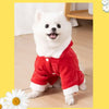 A white dog wearing a red cartoon animal pet costume jumpsuit.