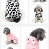 A gray poodle pet costume jumpsuit with black and white spots and a pink version.