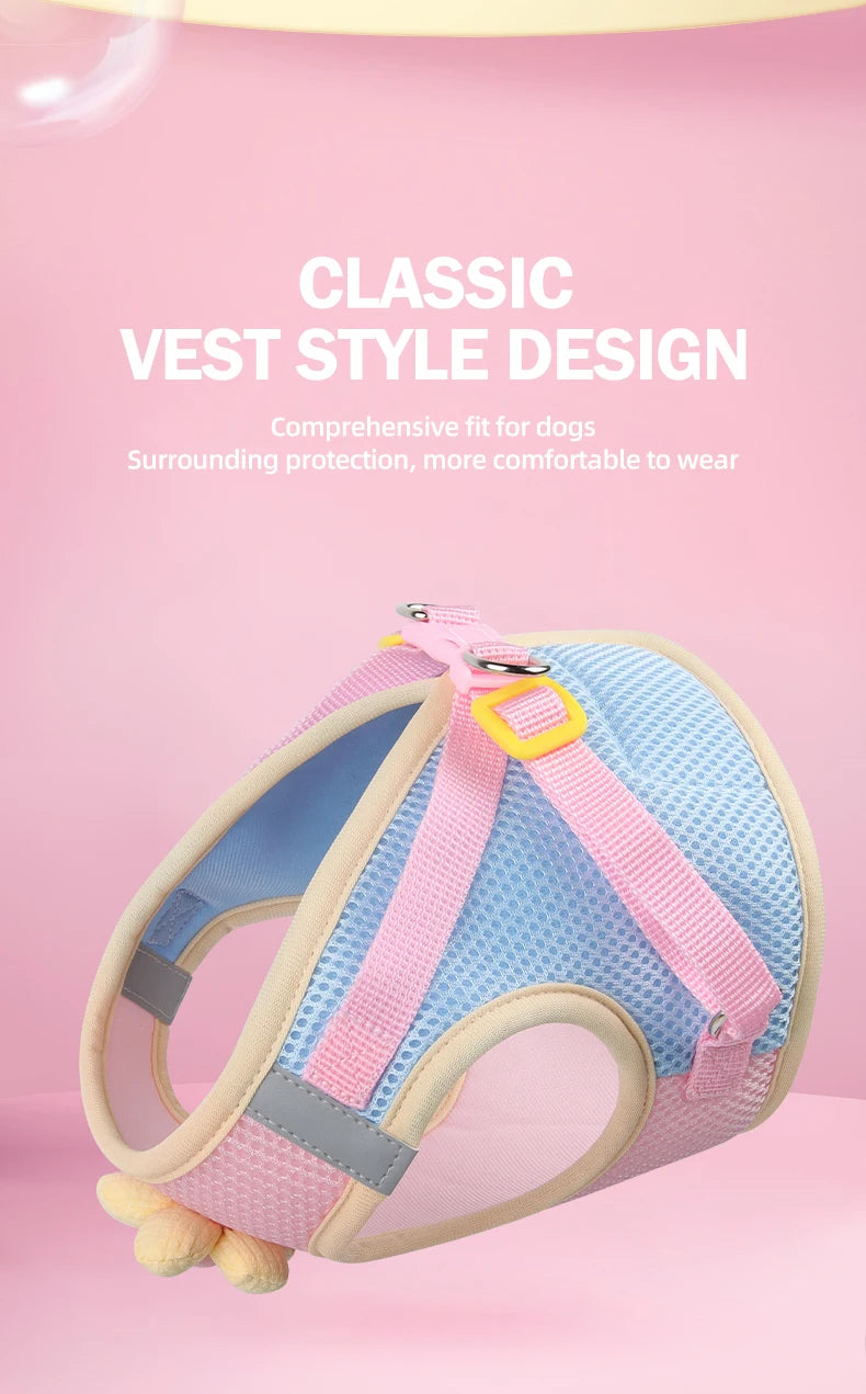 A pink and blue breathable mesh dog vest style harness is shown against a pink background.