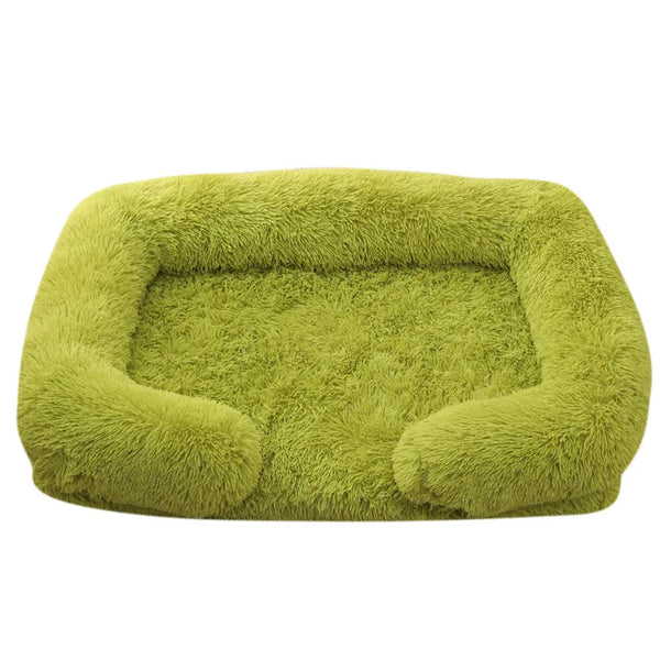 A large, olive green plush dog bed with a removable cover.