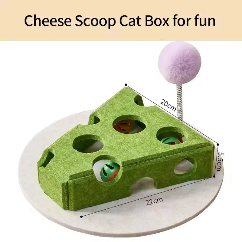 A green felt cat box maze for cats with holes and a pink fuzzy toy