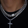 A close-up of a dainty diamond Cuban link necklace set worn around the neck.
