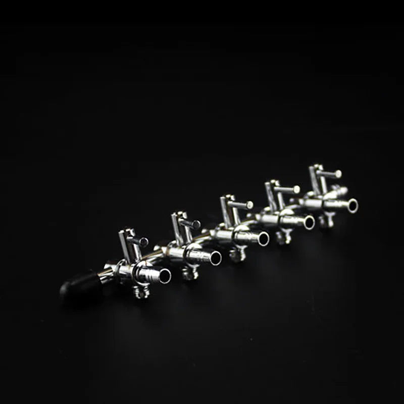 A row of stainless steel aquarium air splitter valves arranged diagonally against a dark background.