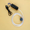 A black portable USB aquarium oxygen pump with a white hose and a blue connector is shown on a light background.