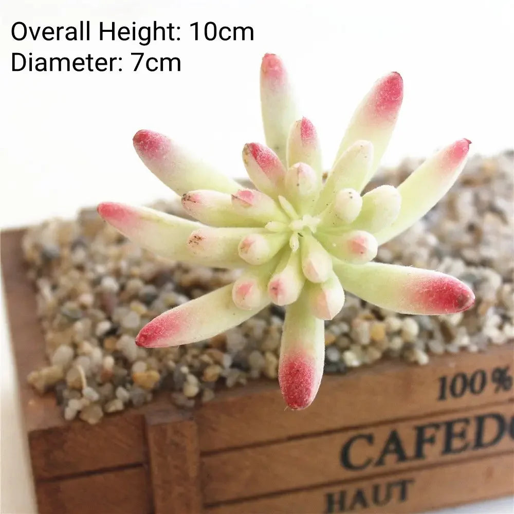 A small, light green flocked artificial succulent plant with pink tips is displayed on a wooden surface.