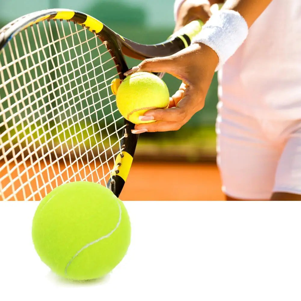 A hand is holding a yellow tennis ball near a tennis racket, with another yellow ball visible in the foreground.