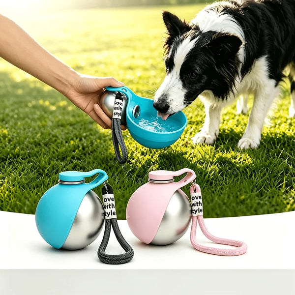 A dog is drinking water from a portable stainless steel bottle with a built-in bowl, held by a person.