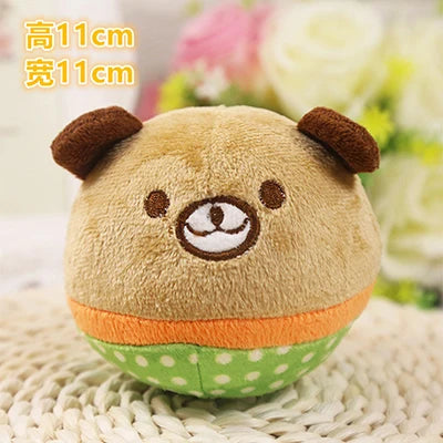 A cute, light brown plush toy resembling a bear with brown ears and a white nose, resting on a woven surface.