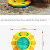 A yellow and teal interactive dog slow feeder puzzle toy being used by a dog.