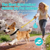 A happy dog is walking on a path while a woman carries a two-piece dog poop bag holder for hands-free convenience.
