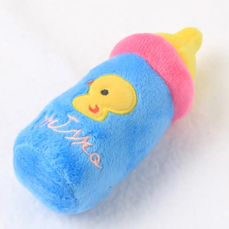 A blue bone-shaped squeaky plush dog toy with a yellow face and pink ear.