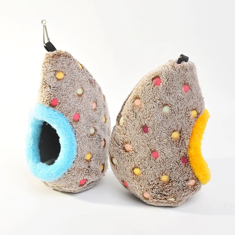 A fluffy, brown and gray bird nest shaped like a pear is shown for hanging cages.
