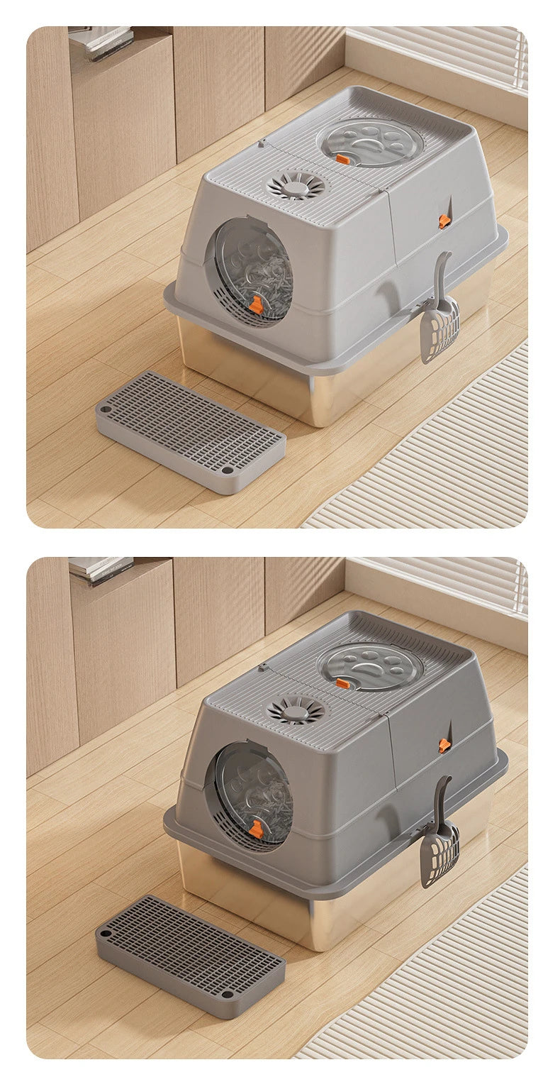 A gray fully enclosed stainless steel cat litter box with a flip-top lid and a separate grate shown on a wooden floor.