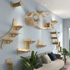 Wall-mounted wooden cat tree and hammock featuring natural wood tones on a light blue wall.