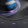 A blue and white interactive rolling dog toy ball is shown in motion on a gray surface.