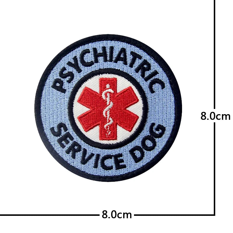 Round embroidered patch with blue and black text and a red cross design for psychiatric service dog training.