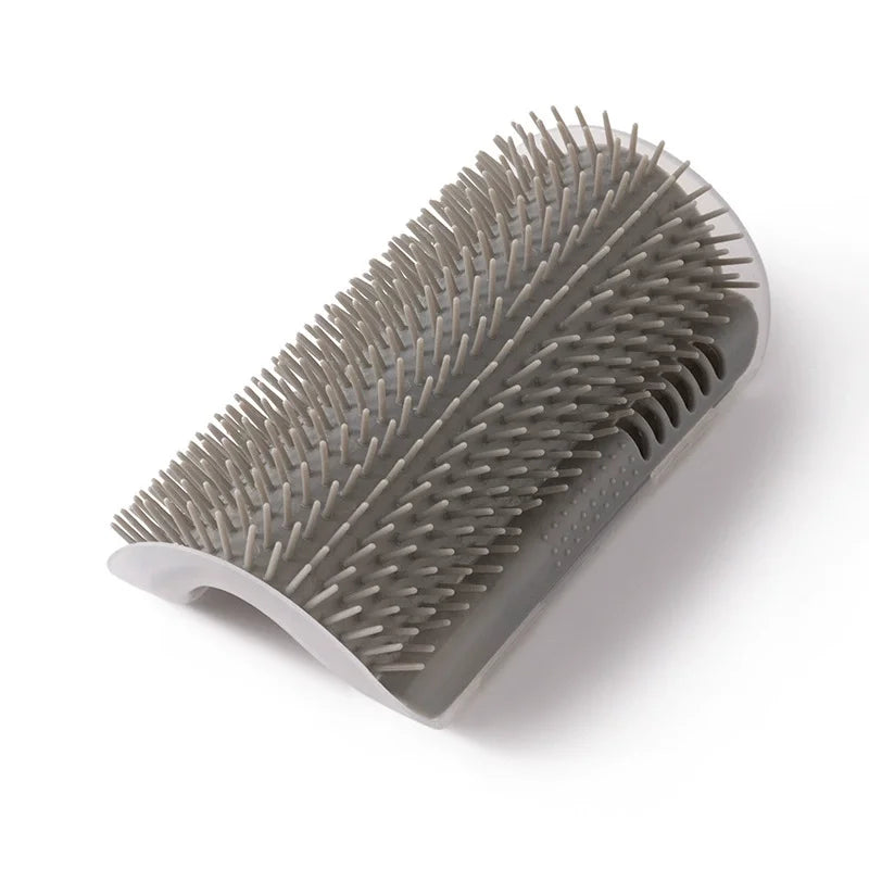 A gray cat corner scratcher and massage brush with numerous pointed bristles.
