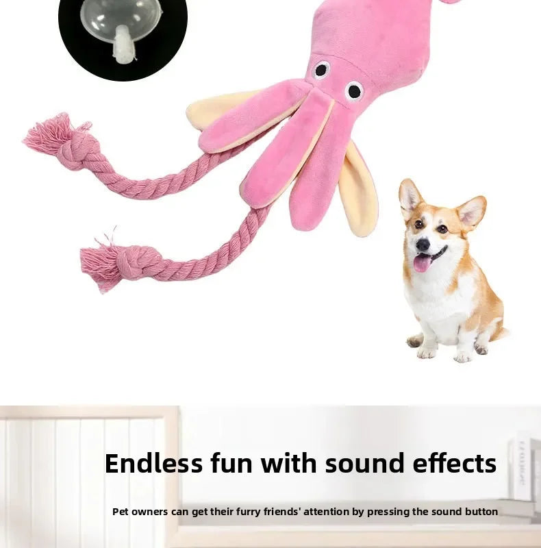 A pink squeaky octopus dog toy with a cotton rope tail and a small dog playing with it.