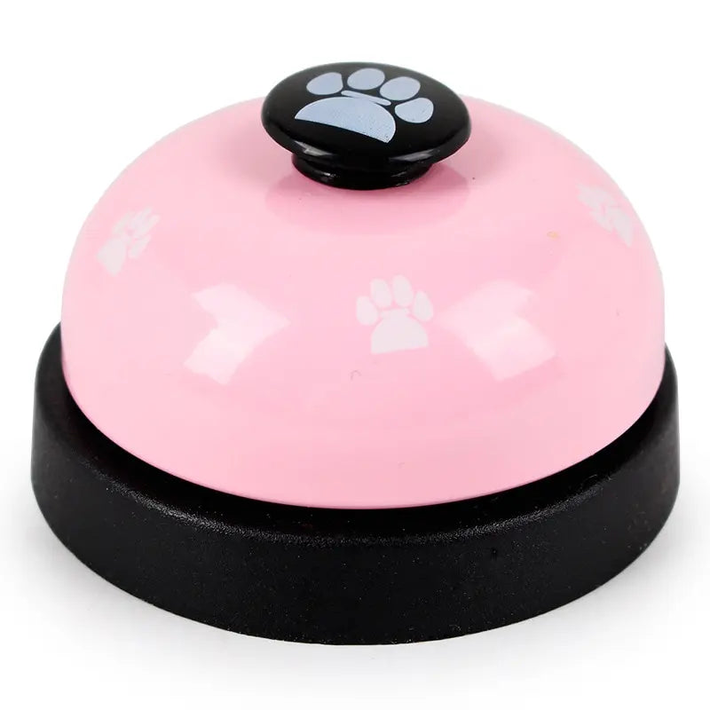 A pink and black footprint pet training bell with a black top.