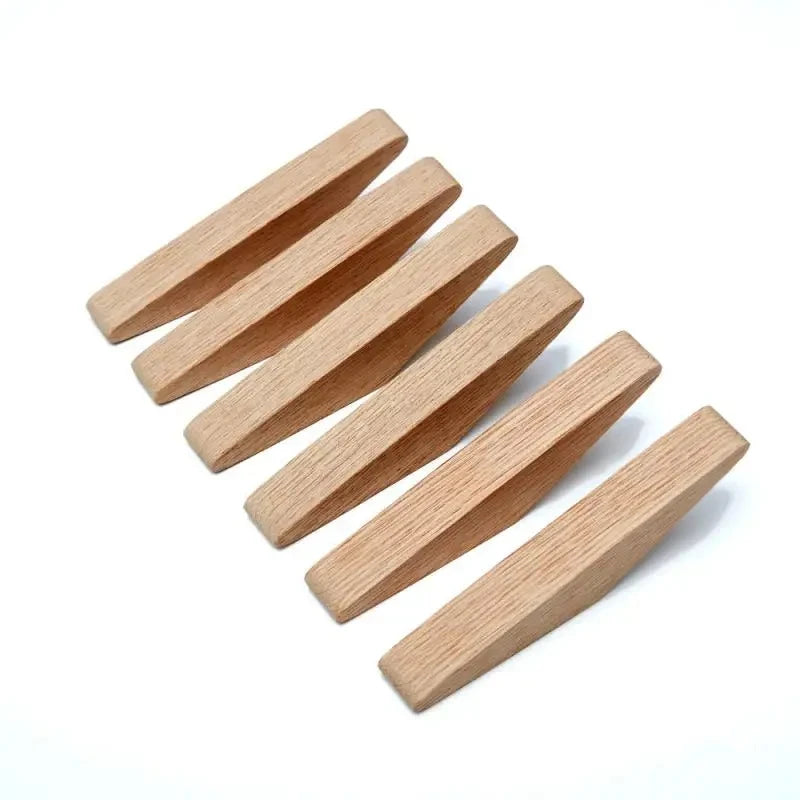 A set of three light brown oak wood wall mounted triangle coat hooks arranged diagonally.