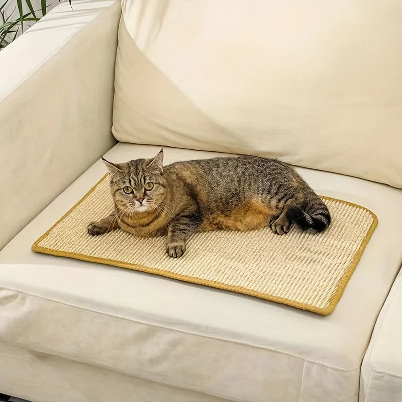 A tabby cat is relaxing on a beige sisal scratching mat placed on a light-colored sofa cushion.