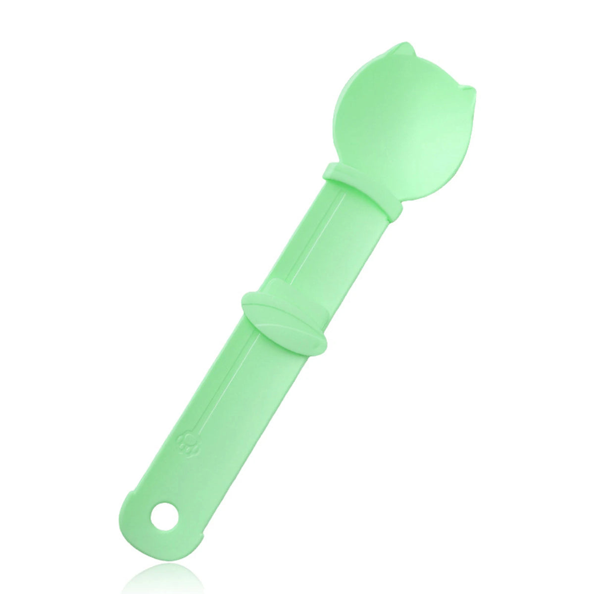 A light green squeeze spoon feeder for liquid cat treats.