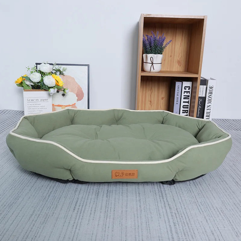 A light green luxurious corduroy pet sofa bed for dogs and cats resting on a gray surface.
