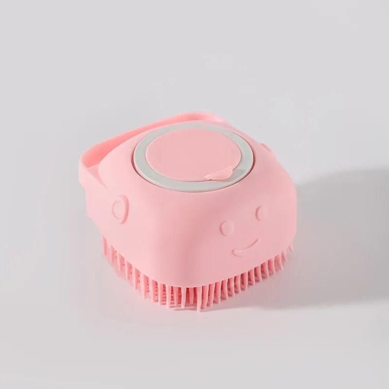 A pink pet bath massage brush with a shower gel dispenser is shown against a light gray background.