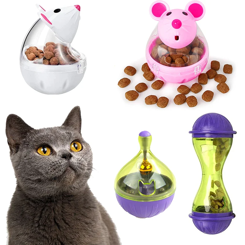 A pink and white interactive cat food dispensing ball toy with various food pellets and a purple hourglass-shaped feeder.