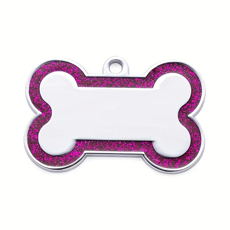 Silver dog bone shaped pet ID tag with pink glitter outline and a loop for collar attachment