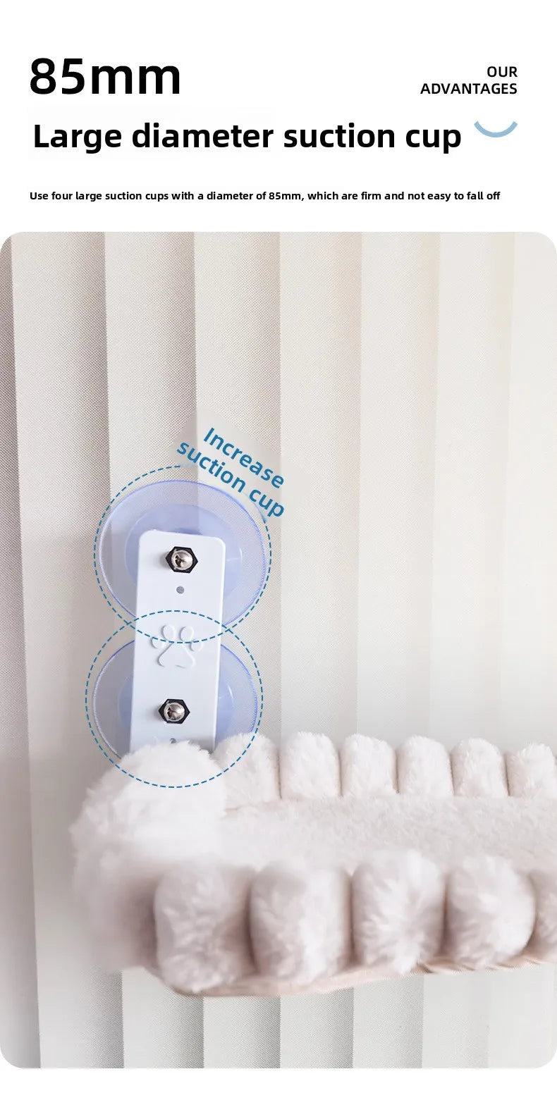A close-up of a white cat window perch hammock featuring large suction cups for secure mounting.