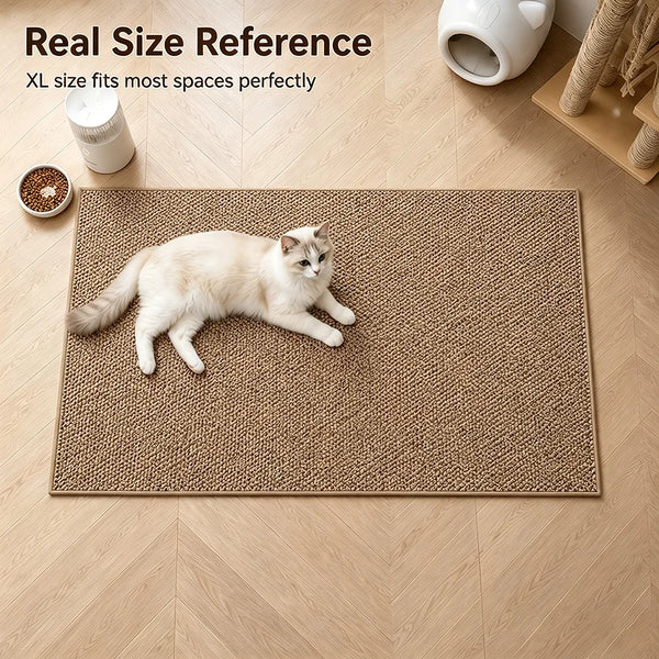 A fluffy gray cat is lying on a brown faux sisal scratching mat placed on a light wood floor.