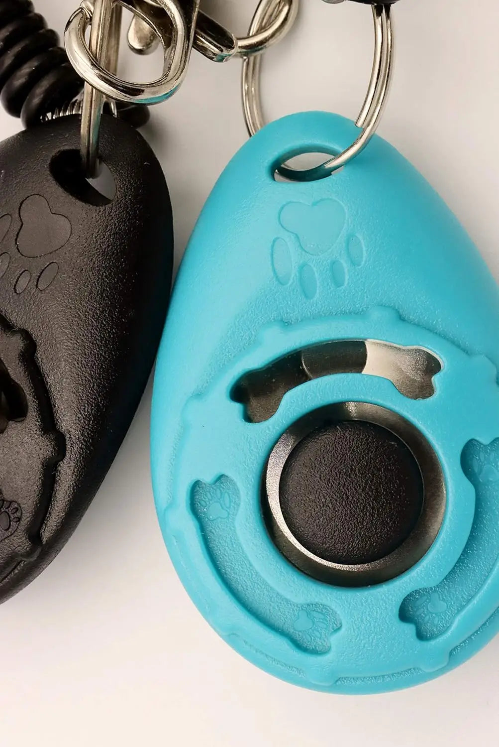 A bright blue pet training clicker with a black silicone body and silver hardware.