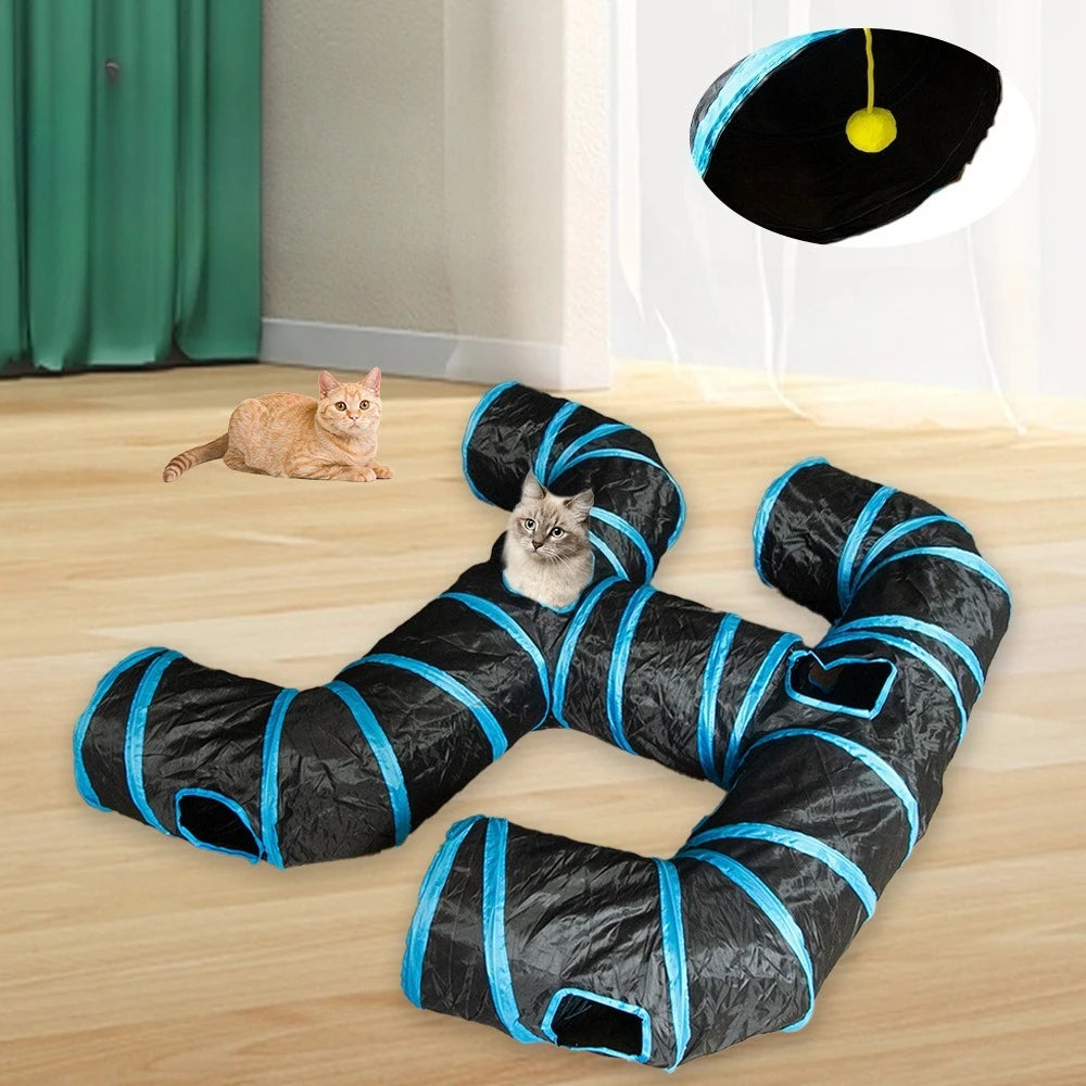 A black and blue foldable cat tunnel with multiple entrances lying on a wooden floor.