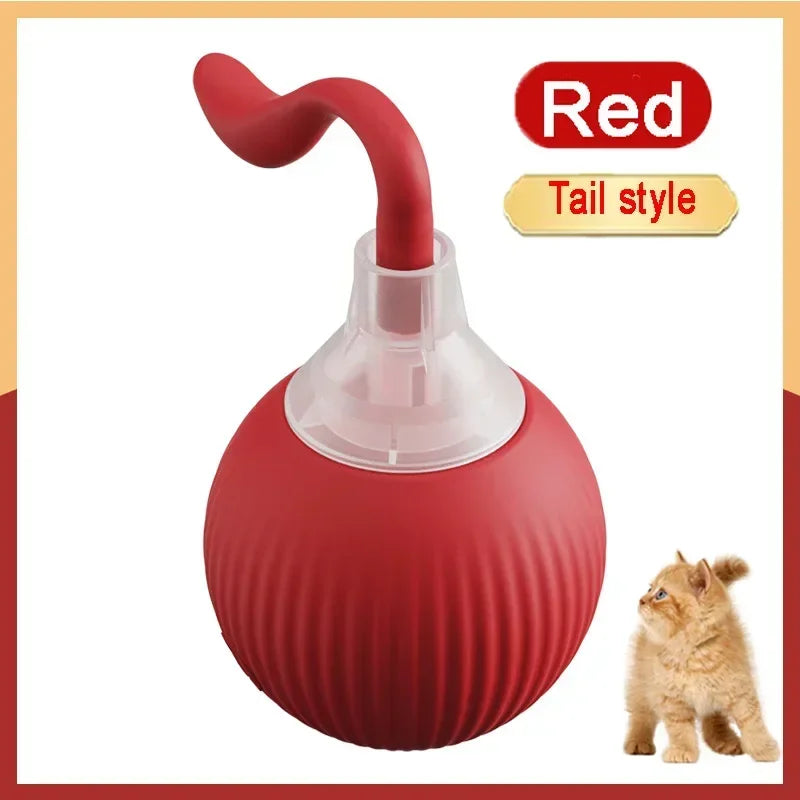 A red, ball-shaped interactive prey-simulating pet toy with a nozzle and a small kitten nearby.