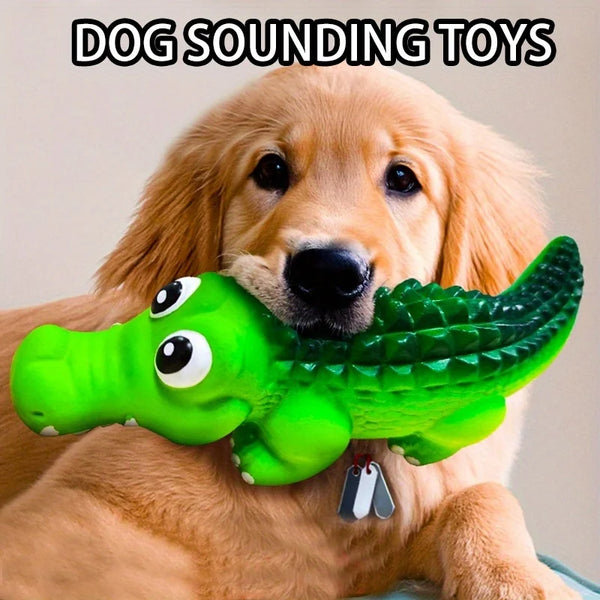 A golden retriever is holding a bright green crocodile-shaped latex dog chew toy with a squeaker.