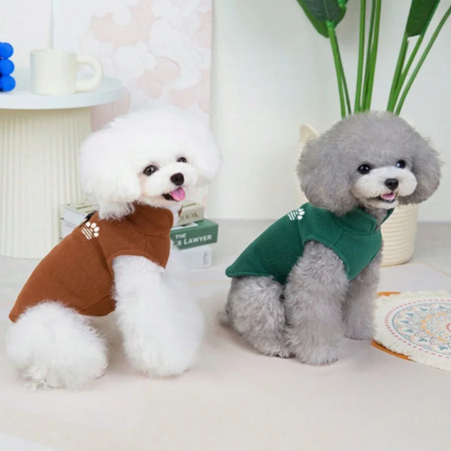 Two fluffy dog sweaters, one white and one gray, displayed on a white surface.
