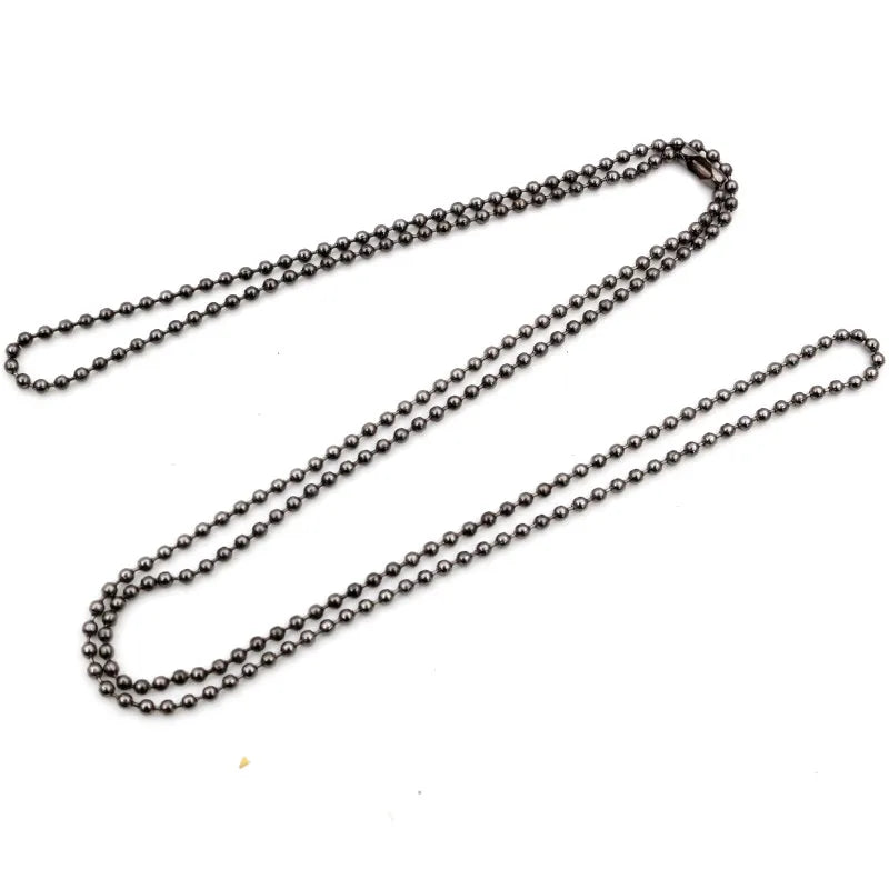 A set of gold and silver plated ball necklaces laid out on a white background.