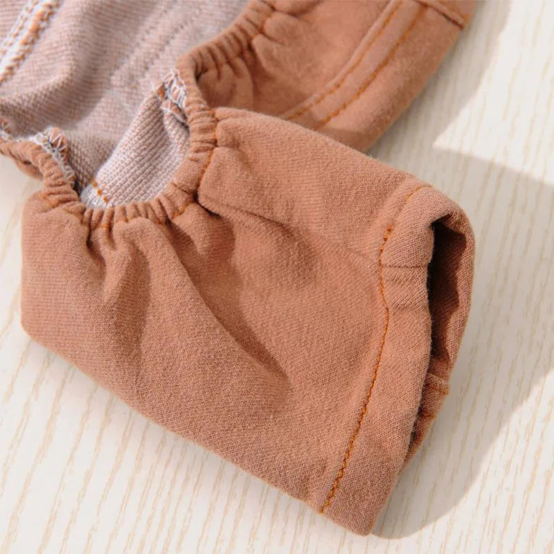 A close-up of a tan dog denim jumpsuit costume for small to medium breeds.