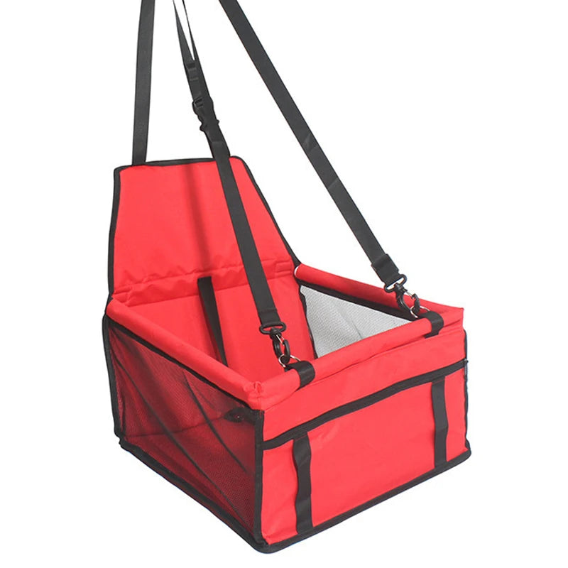 A red car pet seat cushion with a safety belt harness and mesh lining.