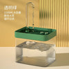 A clear pet water fountain with a green base and an arched dispenser, set against a light background.