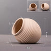 A light beige ceramic aquarium shrimp hideaway cave pot shown from the side and top view.